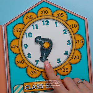May include: A colorful clock face with a teal background and a yellow floral border. The clock has black numbers and a teal hour and minute hand. The text "HOURS" and "MINUTES" are on the hands. The time is set to 7:35. The text "CLASS" is at the bottom.