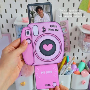 May include: A pink, cartoon-style camera with a photo of a person in a white hoodie. The camera has the text "Guess WHO I see" and "MY LOVE" printed on it. The image also includes the text "This is a Digital Product - Please Read the Full Description Before Purchase."