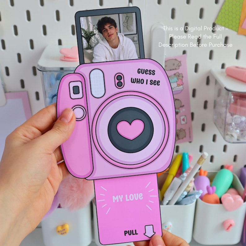 May include: A pink, cartoon-style camera with a photo of a person in a white hoodie. The camera has the text "Guess WHO I see" and "MY LOVE" printed on it. The image also includes the text "This is a Digital Product - Please Read the Full Description Before Purchase."