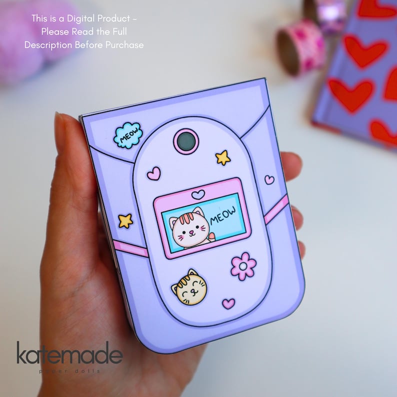 May include: A light purple digital illustration of a flip phone with a screen displaying a cat and the text MEOW. The phone features stickers of a cat face, a flower, stars, and a cloud with the text MEOW. Text at the top reads: This is a Digital Product - Please Read the Full Description Before Purchase.