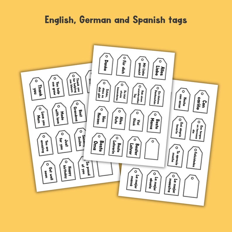 May include: Three sheets of white paper featuring rows of rectangular gift tags with rounded top corners and pre-punched holes. Each tag contains black printed text in English, German, and Spanish, including phrases like Thank you, Danke, and Con cari&ntilde;o.