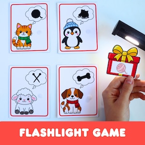 Pode incluir: Um conjunto de quatro cartões educativos retangulares com animais de desenho animado e balões de pensamento contendo silhuetas de um novelo de lã, patins, tesouras e um osso, além de um cartão em forma de presente com um novelo de lã rosa.