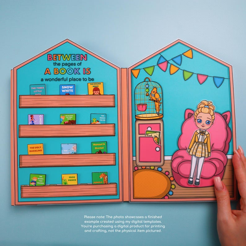 May include: A paper dollhouse with a bookshelf and a room with a doll and a parrot. The bookshelf has miniature books with titles like "Snow White" and "The Ugly Duckling." The room has a pink chair and a parrot in a cage. Text reads "Between the pages of a book is a wonderful place to be."