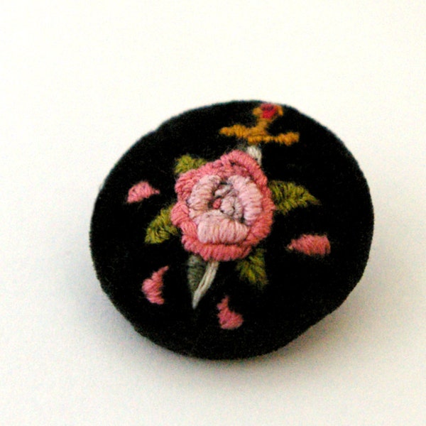 hand-embroidered dagger through rose velvet pin-back button