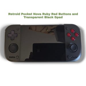 May include: A black handheld gaming console featuring the text Retroid Pocket Nova Ruby Red Buttons and Transparent Black Dpad. The device includes a central screen, a transparent black directional pad, two black joysticks, and four ruby red action buttons.