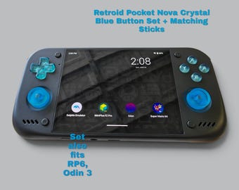 May include: A black handheld gaming console featuring a Retroid Pocket Nova crystal blue button set and matching analog sticks. The screen displays a digital clock and app icons. Text reads: Retroid Pocket Nova Crystal Blue Button Set + Matching Sticks. Set also fits RP6, Odin 3.