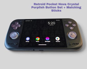May include: A black handheld gaming console with a screen displaying a digital clock at 5:20 and app icons. It features translucent purplish buttons and matching analog sticks. Text above reads: Retroid Pocket Nova Crystal Purplish Button Set + Matching Sticks.