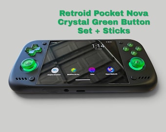 May include: A black handheld gaming console featuring a Retroid Pocket Nova Crystal Green Button Set + Sticks. The device has a central screen displaying a digital interface with app icons and a time of 1:14, surrounded by translucent green controls.