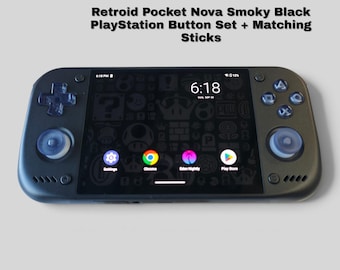 May include: A Retroid Pocket Nova handheld gaming console in smoky black with a PlayStation button set and matching analog sticks. The screen displays a digital interface with app icons and the time 6:18. Text reads: Retroid Pocket Nova Smoky Black PlayStation Button Set + Matching Sticks.