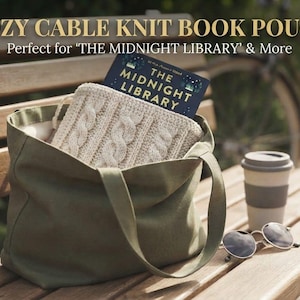 May include: An olive green canvas tote bag containing a cream-coloured cable knit book pouch and a copy of the book The Midnight Library. The text COZY CABLE KNIT BOOK POUCH and Perfect for THE MIDNIGHT LIBRARY & More is visible at the top.