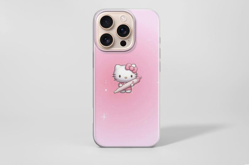 Puede incluir: Una funda de tel&eacute;fono rosa con un personaje de dibujos animados de Hello Kitty sosteniendo un objeto rosa. La funda tiene un fondo degradado y un borde transparente. La funda est&aacute; dise&ntilde;ada para un tel&eacute;fono inteligente.