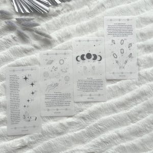 May include: Four rectangular translucent stickers featuring black line art illustrations of celestial bodies, hands, and crystals. Each sticker includes printed text and small star motifs. The designs depict planets, moon phases, and geometric shapes on a clear background.