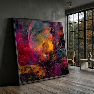 May include: Large framed abstract art print with a vibrant mix of colors. The artwork features a blend of red, yellow, blue, and purple hues, creating a dynamic and textured visual effect. The piece is displayed in a modern interior setting.