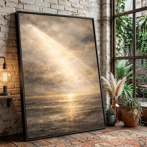 May include: A framed canvas art print depicting a seascape with a dramatic sky. The artwork features a golden light beam shining down on the ocean, creating a sense of serenity. The color palette includes shades of gold, brown, and gray.