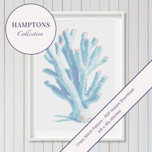 May include: A framed cross-stitch pattern of a coral reef in shades of blue and pink. The artwork is part of the "Hamptons Collection" and is presented in a white frame. The pattern is 116 x 165 stitches.