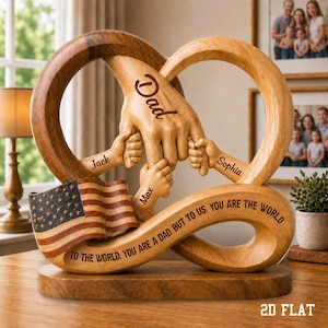 May include: Wooden sculpture featuring an infinity symbol design with carved hands holding smaller hands. The sculpture includes an American flag and the words "Dad", "Jack", "Max", and "Sophia". The base reads "To the world, you are a dad, but to us, you are the world."