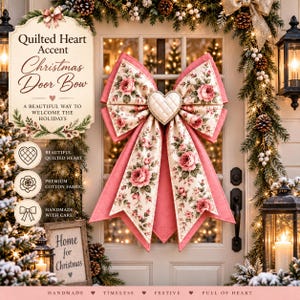 May include: A large decorative door bow featuring a cream-colored fabric with a pink rose floral pattern and solid pink edges. A central quilted heart ornament is attached to the center of the bow. The text Quilted Heart Accent Christmas Door Bow is visible.