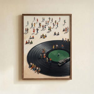 May include: A framed art print depicts a black vinyl record with miniature figures dancing and socializing. The artwork features a brown wooden frame and a cream-colored background, creating a whimsical scene.