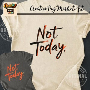 May include: A cream-colored short-sleeve t-shirt featuring the black and orange text Not Today in a brushstroke font, displayed alongside a smaller dark gray t-shirt with the same text in a bright orange brushstroke style font.