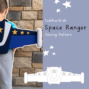 May include: A sewing pattern for a toddler and kids space ranger jetpack. The design features a blue and white wing structure with yellow star accents. The image includes the text 'Toddler/Kids Space Ranger Sewing Pattern' and a line drawing.
