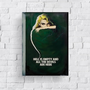 May include: A framed art print depicting a woman with blonde hair and dark eyes, wearing a dark green garment. The artwork includes the text "HELL IS EMPTY AND ALL THE DEVILS ARE HERE" in white lettering.