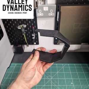 A custom design we created to hold a dust collection box on a milwauke mouse sander.