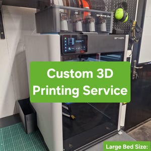 May include: A white and black 3D printer with the text "Custom 3D Printing Service". The printer has a large bed size of 34cm width, 33cm length, and 34cm height. It includes a display screen and a filament storage system.