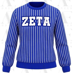 May include: A blue sweatshirt with vertical white stripes. The word "ZETA" is displayed in large white block letters across the chest. The sweatshirt has a crew neck and long sleeves with ribbed cuffs.