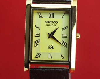 Reloj de pulsera Seiko Slim Quartz para hombre, reacondicionado, con esfera dorada.