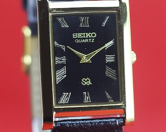 Reloj de pulsera Seiko Slim Quartz para hombre, reacondicionado, con esfera negra.