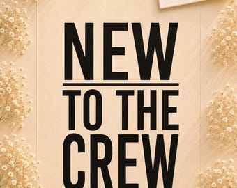 May include: A rectangular sign with a light beige background featuring the black text NEW TO THE CREW in a bold sans-serif font. A small rectangular label in the top right corner displays the text MiniWunder DESIGN with a rainbow icon.