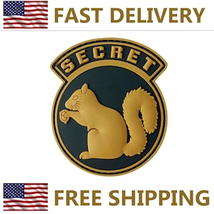 May include: A circular emblem with a gold squirrel silhouette on a dark teal background, framed by a gold border and the word "SECRET". The words "FAST DELIVERY" and "FREE SHIPPING" are above and below the emblem.