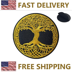 May include: Round black patch with a gold embroidered Tree of Life design. The patch has a detailed Celtic knot pattern and a hook and loop fastener on the back. The words "FAST DELIVERY" and "FREE SHIPPING" are in the image.