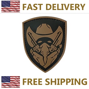 May include: A shield-shaped patch featuring a cowboy hat, two revolvers, and a masked face in shades of brown and black. The patch has a black border and the words "FAST DELIVERY" and "FREE SHIPPING" are visible.
