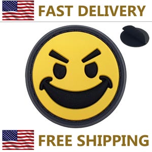 May include: A yellow and black smiley face patch with an evil grin. The patch has a black border and a peel-off adhesive backing. The words "FAST DELIVERY" and "FREE SHIPPING" are printed above and below the patch.