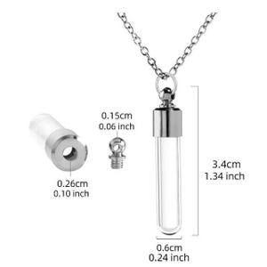 Op de afbeelding: Een ketting met een hanger van een heldere glazen flacon en een zilverkleurige ketting. De flacon is 3,4 cm lang en 0,6 cm breed. De afbeelding toont ook een losgemaakt flacononderdeel en een schroefdop, met afmetingen in cm en inches.