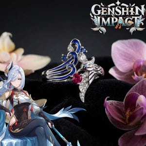May include: A silver ring with a blue enamel design, small diamonds, and a red gemstone. The ring has a unique, artistic shape. The Genshin Impact logo is visible in the background, along with purple orchids.
