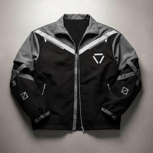 May include: Black and gray jacket with a full zipper, featuring a stand-up collar and a geometric design on the chest and sleeves. The jacket has gray accents and reflective stripes, with a minimalist aesthetic.