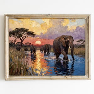 May include: An oil painting of a herd of elephants crossing a river at sunset. The sky is a mix of orange, yellow, and purple hues. The elephants are depicted in shades of gray and brown, with long tusks. The painting is framed in a gold-colored frame.