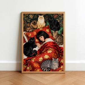 May include: A framed art print depicts a person in bed surrounded by several cats. The bedding is red with a gold leaf pattern. The cats are various colors, including black, orange, and gray. The background is a dark floral pattern.