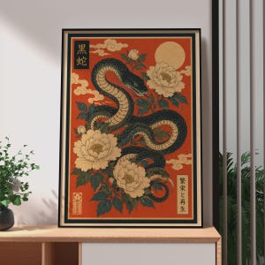 May include: A rectangular wall art print featuring a dark green snake coiled among large white peony flowers on a vibrant orange background. The design includes a pale yellow moon, stylised clouds, and vertical black text boxes with Japanese characters.