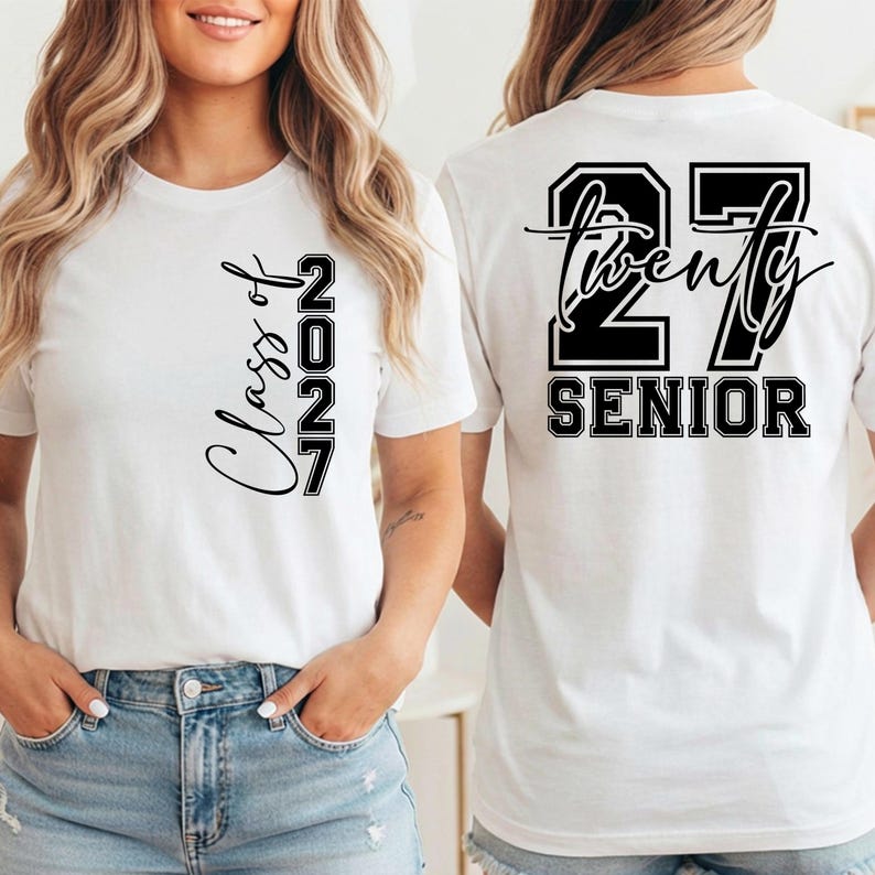 May include: White t-shirt with the text "Class of 2027" on the front and "27 Twenty SENIOR" on the back, in black lettering. The shirt is a crew neck style and is being worn by a person.
