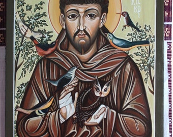 May include: A painting of Saint Francis of Assisi, a Catholic saint, holding a bird and an owl in his hands. The painting is done in a traditional style with a gold halo around the saint's head. The background is a green and brown landscape with birds flying around.