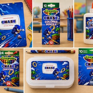May include: A collection of Sonic the Hedgehog themed school supplies including a composition book, a box of 12 Crayola colored pencils, a bottle of Elmer's school glue, a glue stick, a box of 24 Crayola crayons, a pencil, a pencil case, and markers.