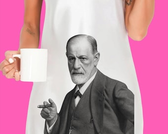 May include: A white sleeveless slip dress featuring a large black and white photographic print of Sigmund Freud wearing a suit and holding a cigar. The garment has a V-neckline and thin spaghetti straps, presenting a clear portrait of the historical figure.