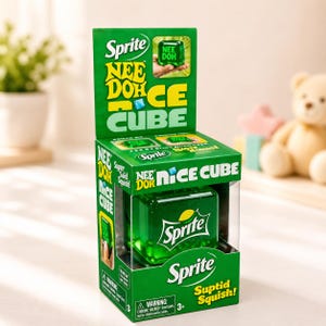 May include: A green box featuring a Sprite Nee Doh Nice Cube. The box has the Sprite logo and the words "NEE DOH NICE CUBE" in large letters. The cube is a green, squishy toy with the Sprite logo. The box also says "Suptid Squish!"