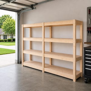 May include: A large, light-coloured wooden shelving unit featuring four horizontal tiers across two connected sections. The structure is built with vertical support posts and horizontal beams, providing an open storage design for organisation.