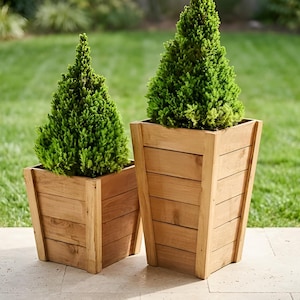 May include: A handmade wooden sign with the text "Welcome to our home" in a handwritten style. The sign is painted white with a dark stained frame. A small green plant is placed on the sign.