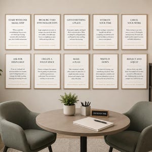 May include: A set of ten framed wall art prints featuring motivational text and productivity advice. Each print has a light background with black lettering, organized in two rows of five, displayed above a round table with two chairs.