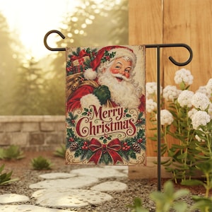 May include: A rectangular garden flag featuring a vintage-style illustration of Santa Claus carrying a sack of gifts. The text Merry Christmas is printed in red script below Santa, surrounded by pine branches, holly, and a large red bow.